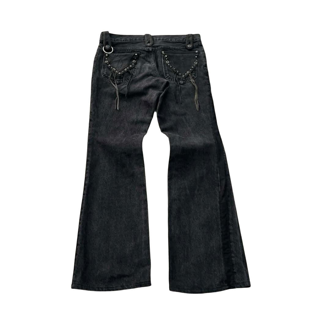 Gothic Cross Black Flared Jeans - Cyber Grunge Gothic Cross Black Flared Jeans - Cyber Grunge These black flared jeans feature a bold Gothic-Grunge aesthetic. The standout feature is the oversized gothic cross with tribal scrollwork printed on the left th