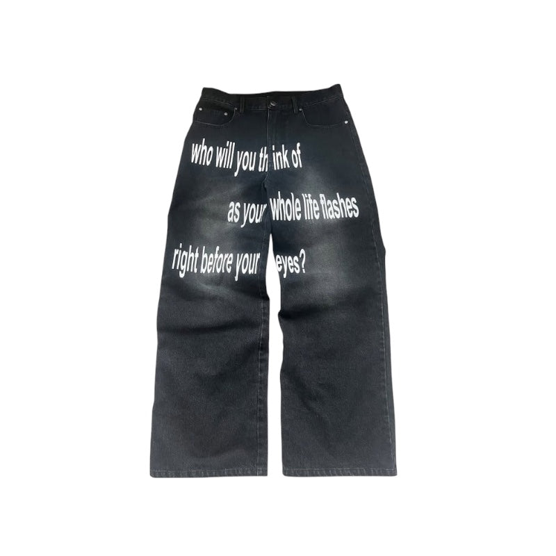 Y2K graphic wide-leg denim jeans with bold text design featuring existential questions on a dark background.