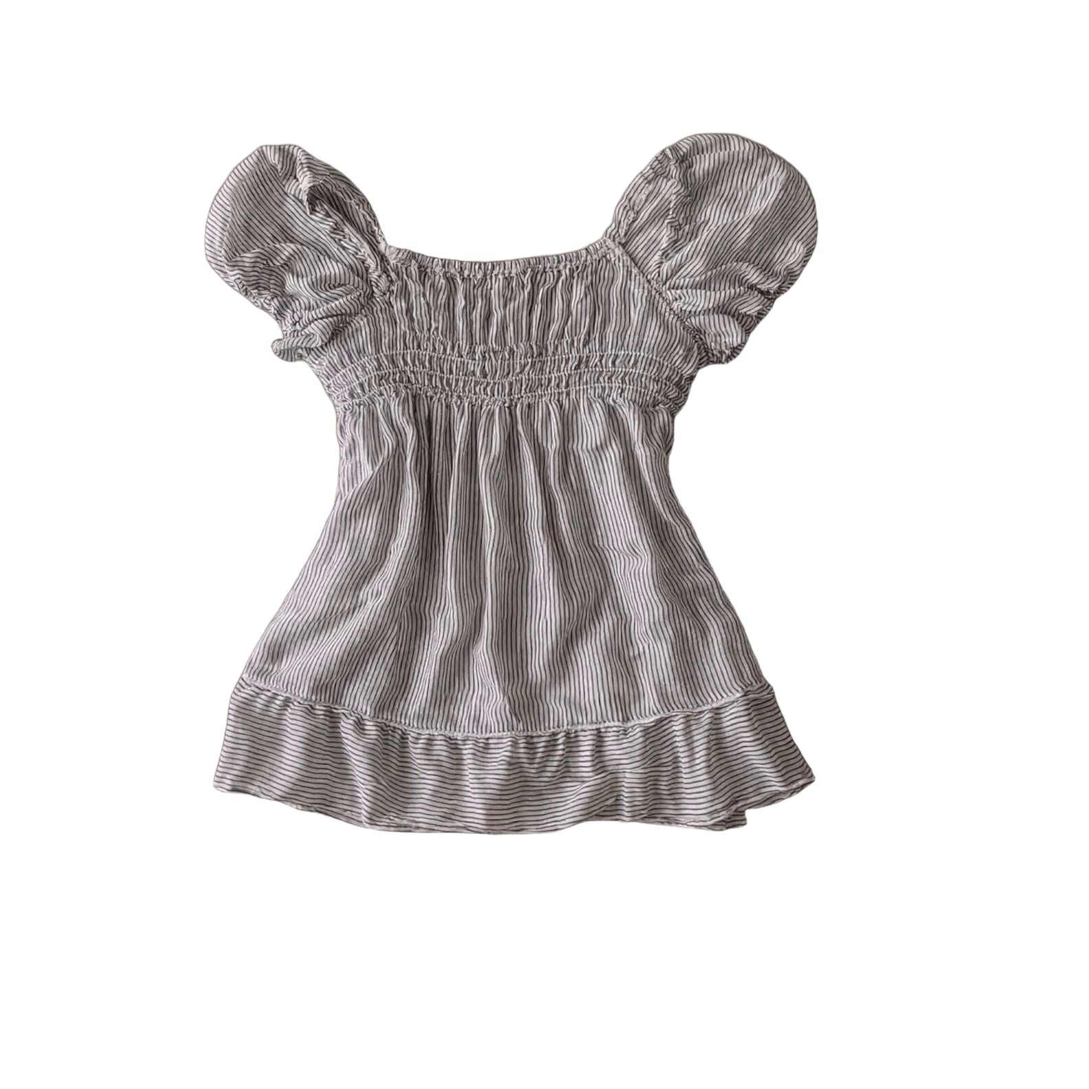 Grey Pinstripe Peplum Top with Front Bow Grey Pinstripe Peplum Top with Front Bow This grey pinstripe peplum top features a square neckline, an elasticated smocked bodice, and a statement adjustable self-tie bow detail on the front. Designed with short pu