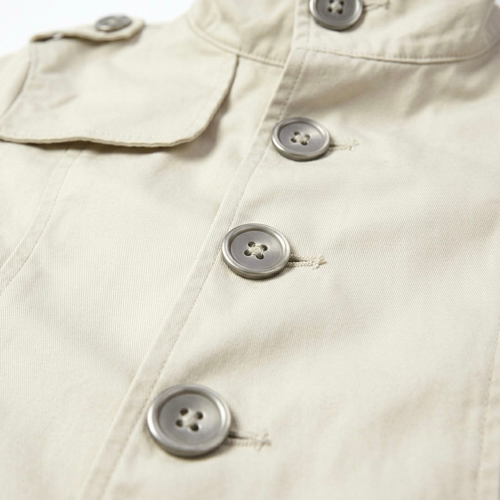 cream button-front short sleeve jacket with high-neck collar and buttons, perfect for summer fashion.