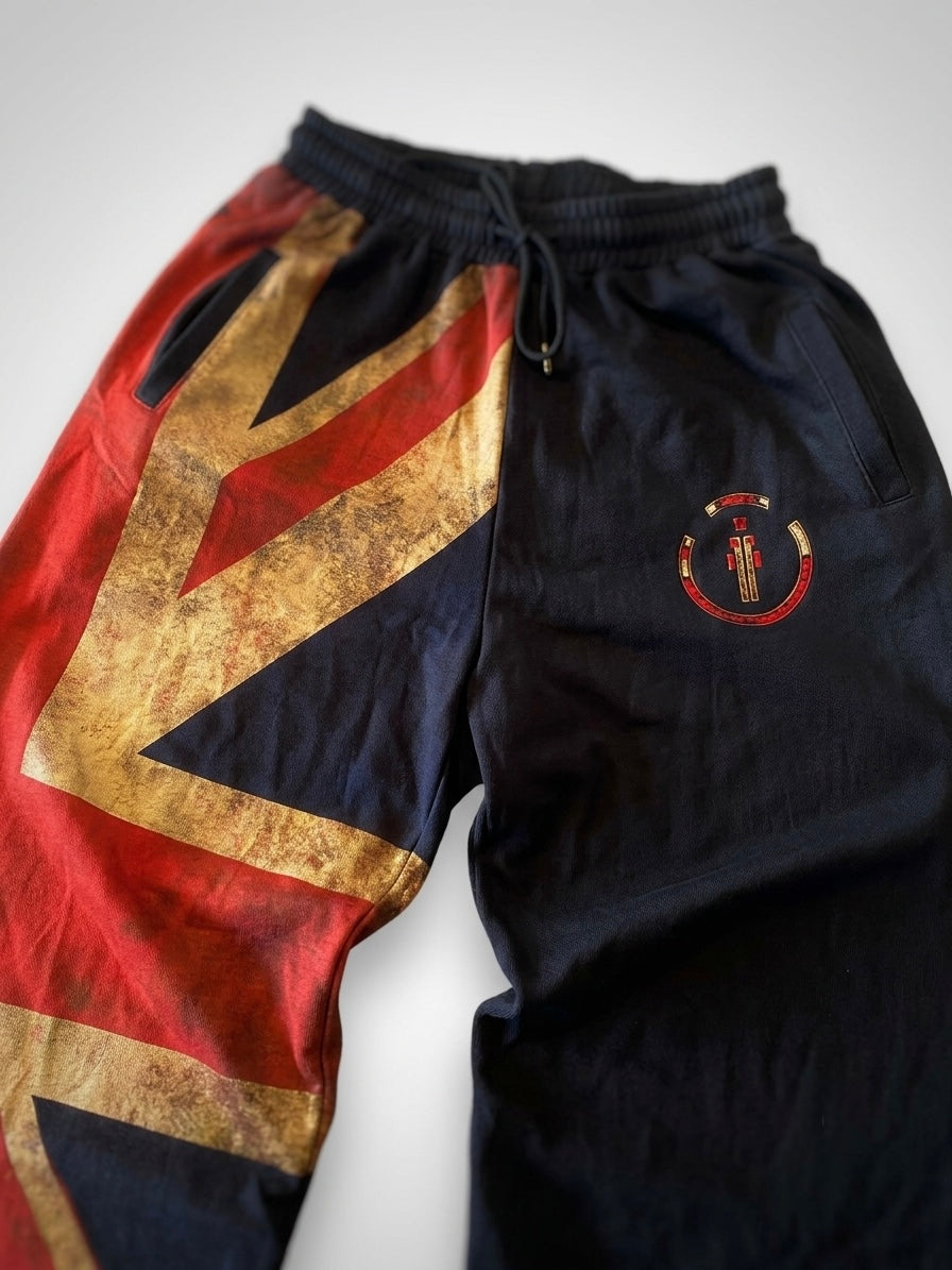 Union Jack straight pants with asymmetrical design featuring vintage gold Union Jack print and solid black leg in streetwear style