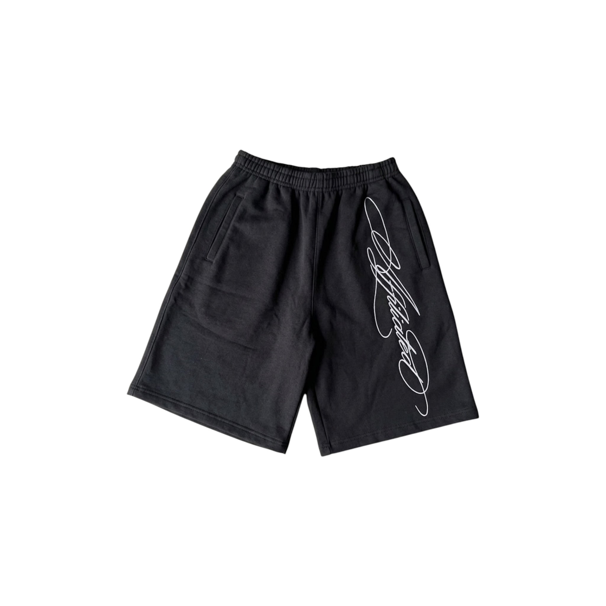 Oversized streetwear shorts in black with a stylized cursive signature design.
