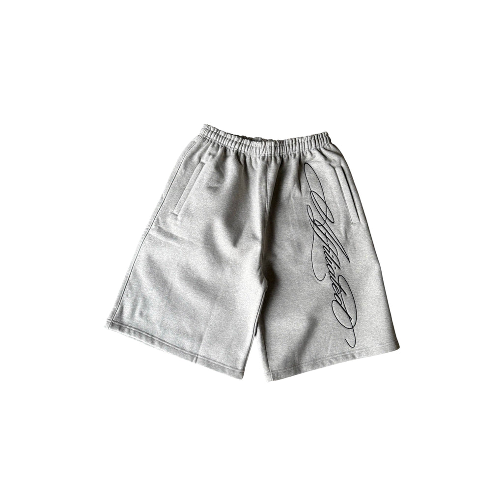 Oversized streetwear shorts in grey featuring a cursive signature design down the side.