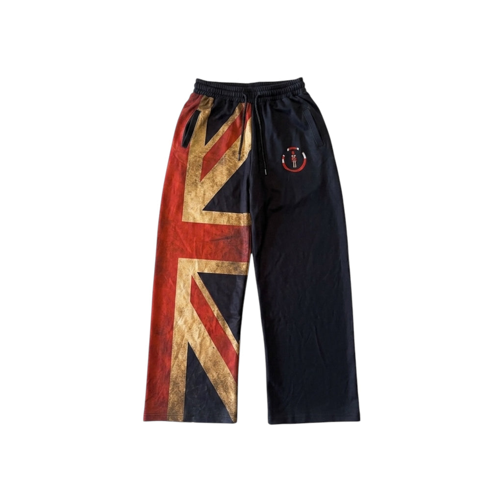 Union Jack straight pants with asymmetrical design, vintage gold Union Jack print on one leg, solid black on the other, streetwear and workwear style.
