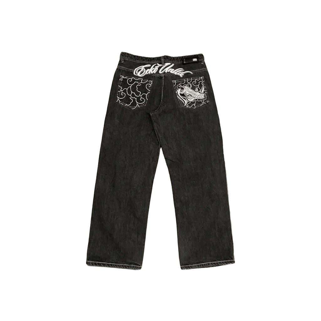 Y2K Rhino Graph Baggy Jeans in faded black denim with wide-leg fit and bold embroidered rhino and cloud graphics on back pockets